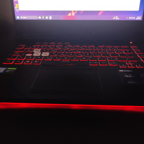 ASUS ROG Strix G531GT gaming laptop with headphones and keyboard