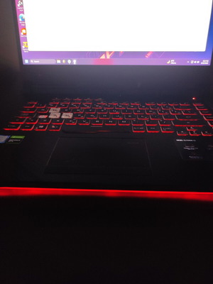 ASUS ROG Strix G531GT gaming laptop with headphones and keyboard
