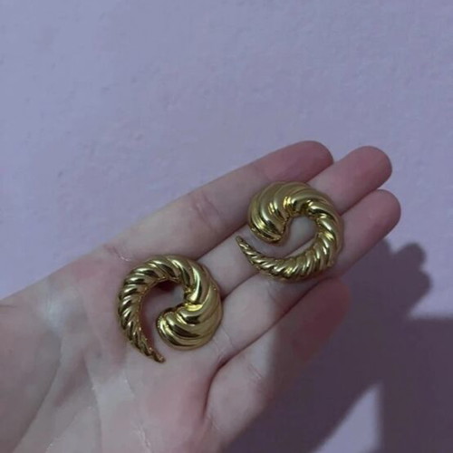 Gold earrings in snake, crescent, and spiral shapes like new