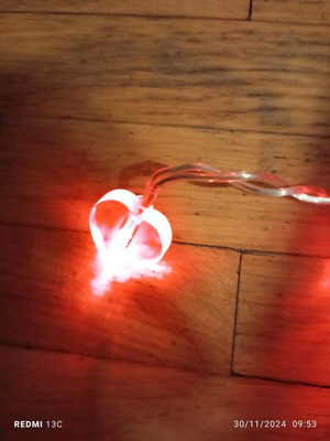 Heart-shaped string lights used with power, white cable