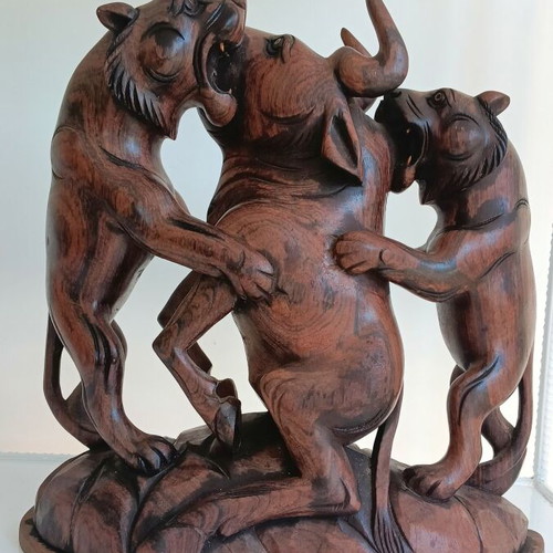 Hunting scene with buffalo and predators wood carving