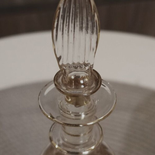 Glass perfume bottle used with golden accents and cap