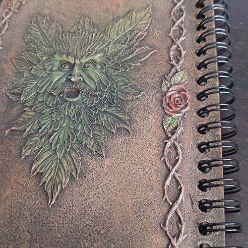 Iron notebook like new with embossed designs and magnet