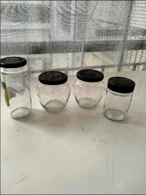 Glass jars with black lids used, set of four