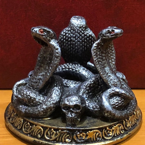 Decorative figurine with snakes and skulls