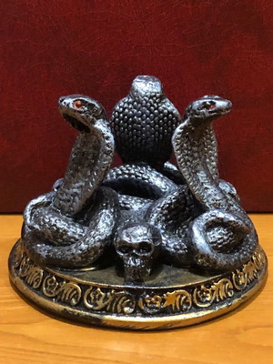Decorative figurine with snakes and skulls