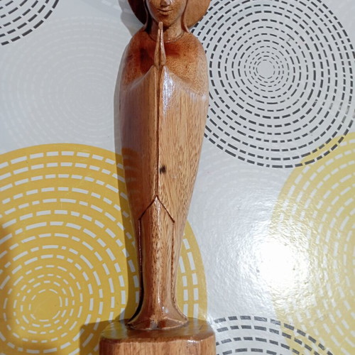 Handmade wooden Madonna statue in praying pose with halo