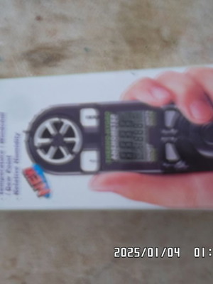 Handheld anemometer used with temperature display