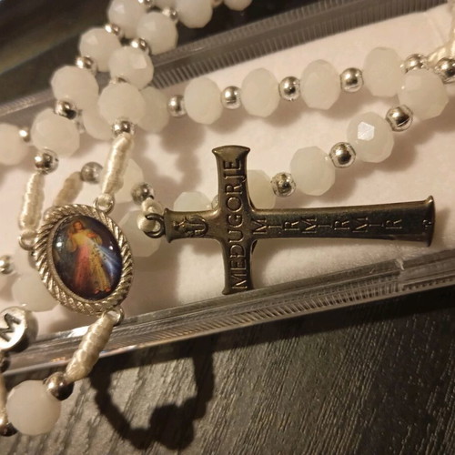 Old rosary in plexiglass case new