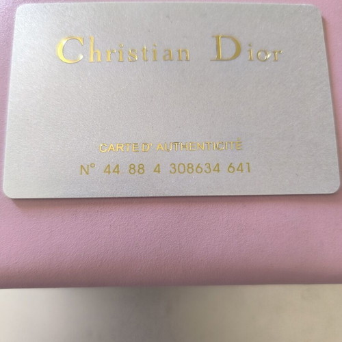 Dior wallet used, pink with slight wear and missing stud