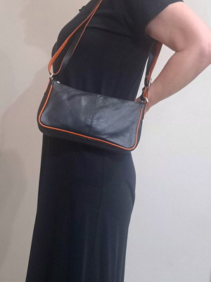 Black leather crossbody bag with orange details, Artisanal Leather Collection