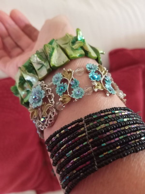 Bracelets like new, three with turquoise and green stones and one black iridescent
