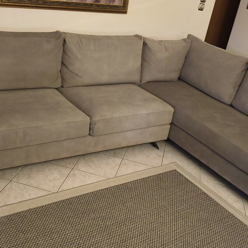 Corner sofa like new in grey/beige taupe color with decorative pillows