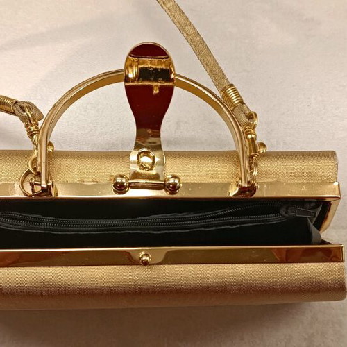 Gold evening handbag like new with missing rhinestone