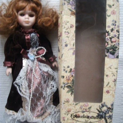 Porcelain doll used with base, box and accessories