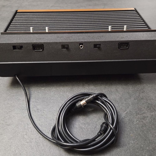Atari 2600 VCS Woody console used with two joysticks and Demon Attack game