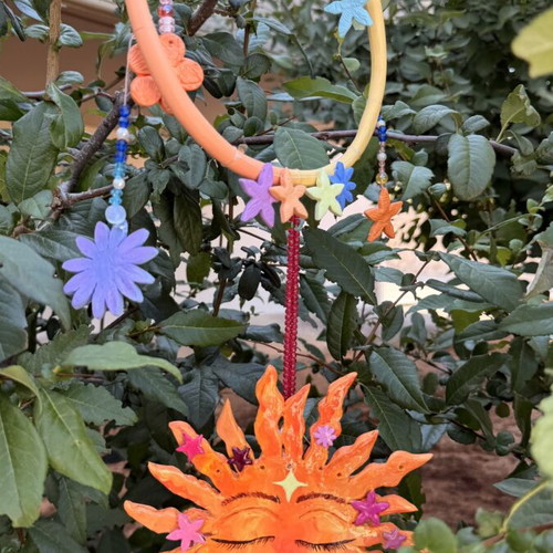 Handmade clay mobile with sun and flowers