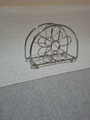 Napkin holder like new, silver with flower design