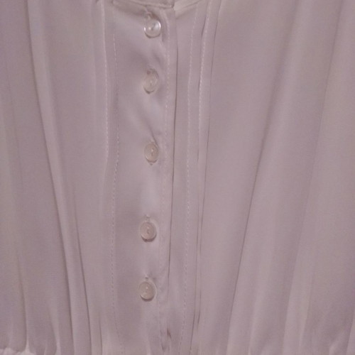 Two white dresses used, sizes 12-14 for girls