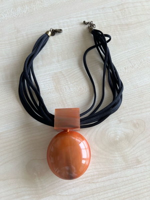 Women's pendant like new with orange motif and leather tie
