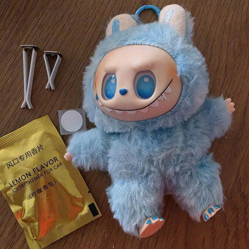 Labubu doll with car seat attachment