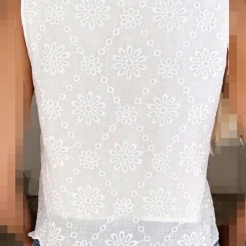 White sleeveless blouse with embroidered flowers