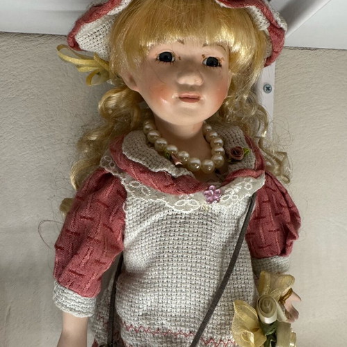Porcelain doll new with tag and base
