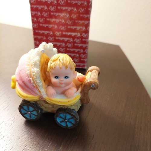 Decorative collectible baby stroller with baby and bottle like new