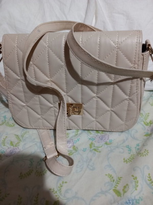 Ecru crossbody bag used with stain on back