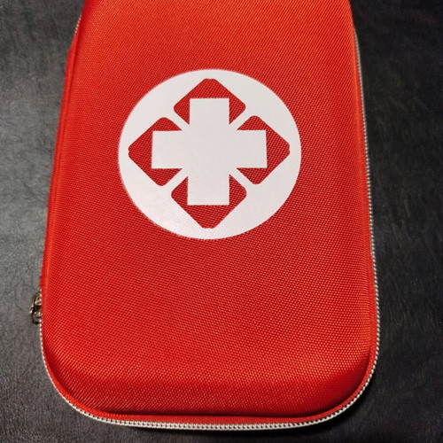 Car first aid kit new, complete in red color