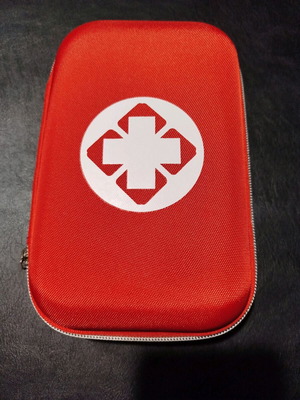 Car first aid kit new, complete in red color