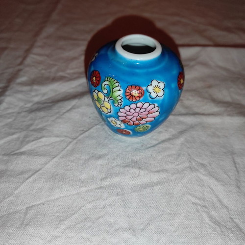 Small blue vase with porcelain flowers used