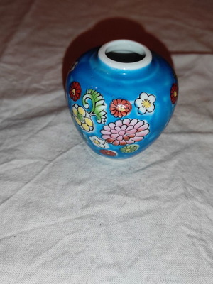 Small blue vase with porcelain flowers used