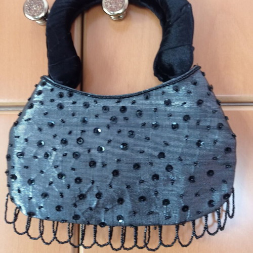 Women's handbag new with metallic silver-gray base and black velvet rosettes