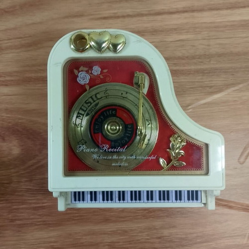 White piano music box with golden record and rose design