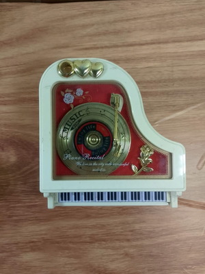 White piano music box with golden record and rose design