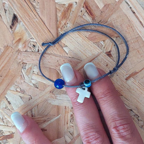 Bracelet with cross charm and evil eye protection