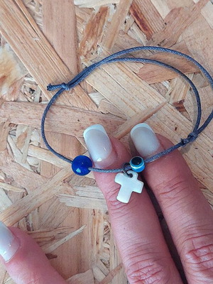 Bracelet with cross charm and evil eye protection
