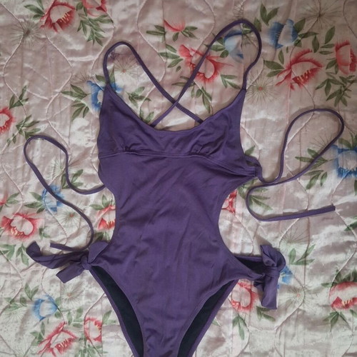 One-piece swimsuit used, purple with cut-outs and adjustable ties, size M