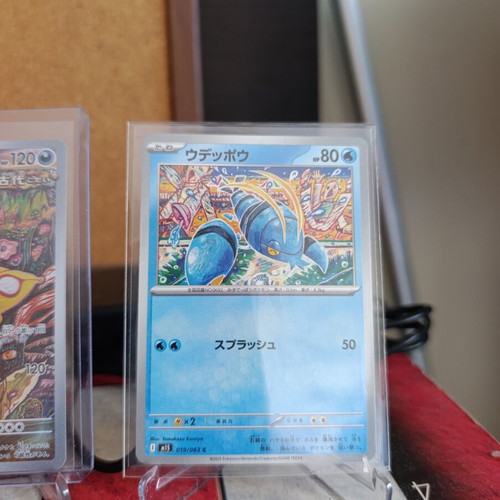 Japanese Pokemon TCG cards with 5 card stands