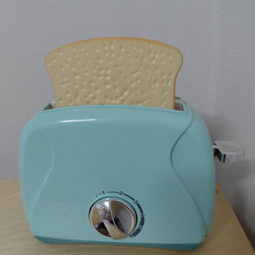 Toy Toaster like new with realistic functions and two fake bread slices