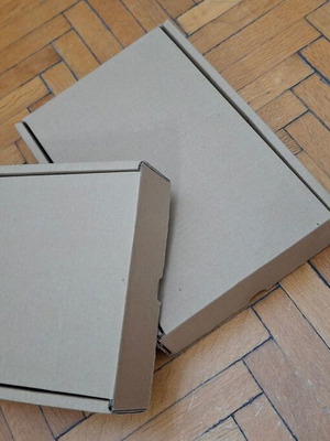 Four courier shipping boxes, kraft cardboard
