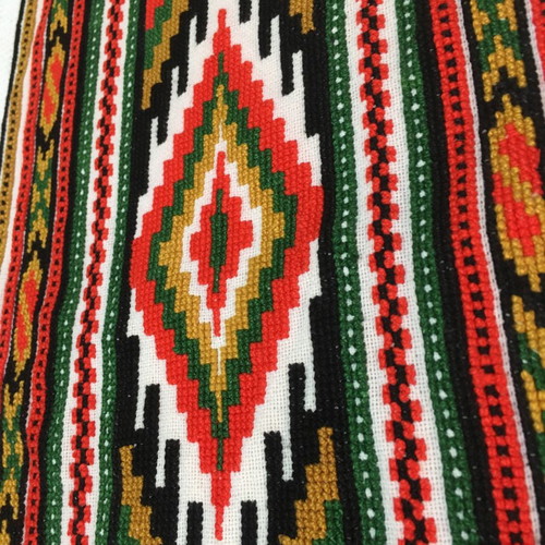 Set of handmade cross-stitch table runners with geometric patterns