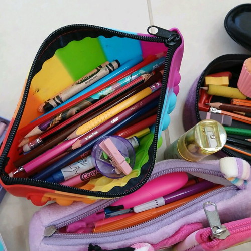 School supplies used, pencil cases, erasers, paints, notebooks, pencils