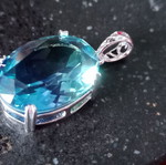 Pendant with blue lab topaz in silver-plated base like new