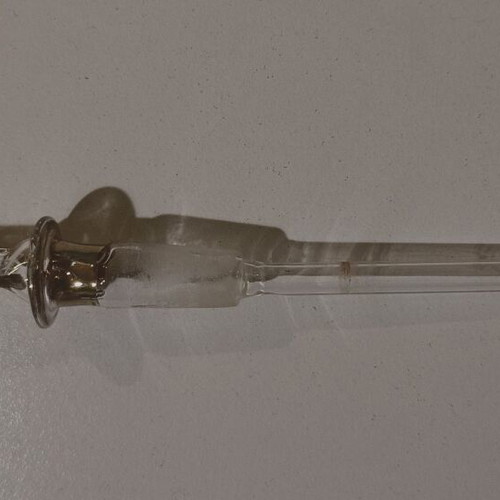 Glass perfume bottle used with golden accents and cap