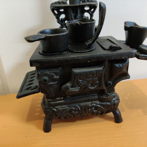 Miniature wooden stove with cast iron accessories like new