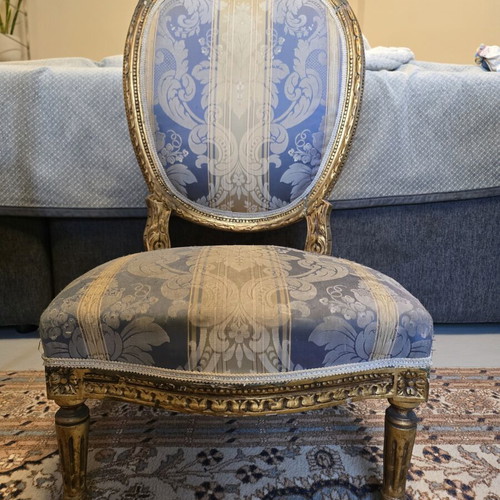 Handcrafted antique chair with fabric and carved wood