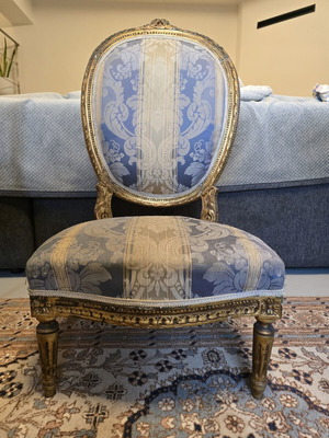 Handcrafted antique chair with fabric and carved wood