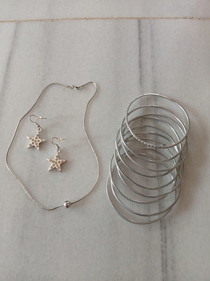 Jewelry set like new with nine bracelets, star earrings, and ball necklace